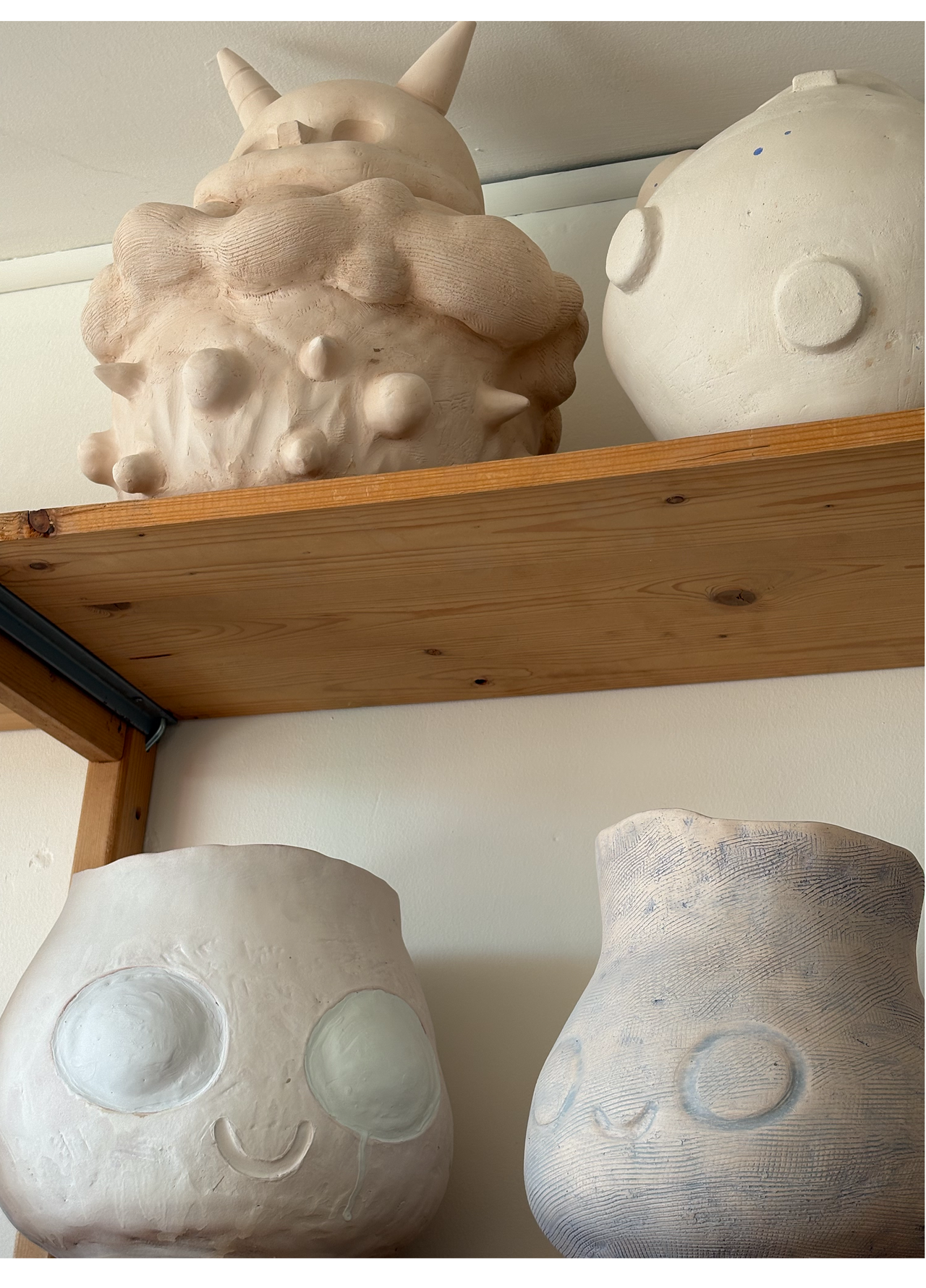 4 different sculptures by Coodre on a shelf