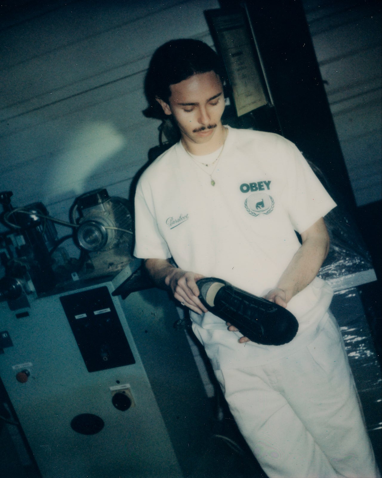 Model holding the Paraboot x Obey shoe