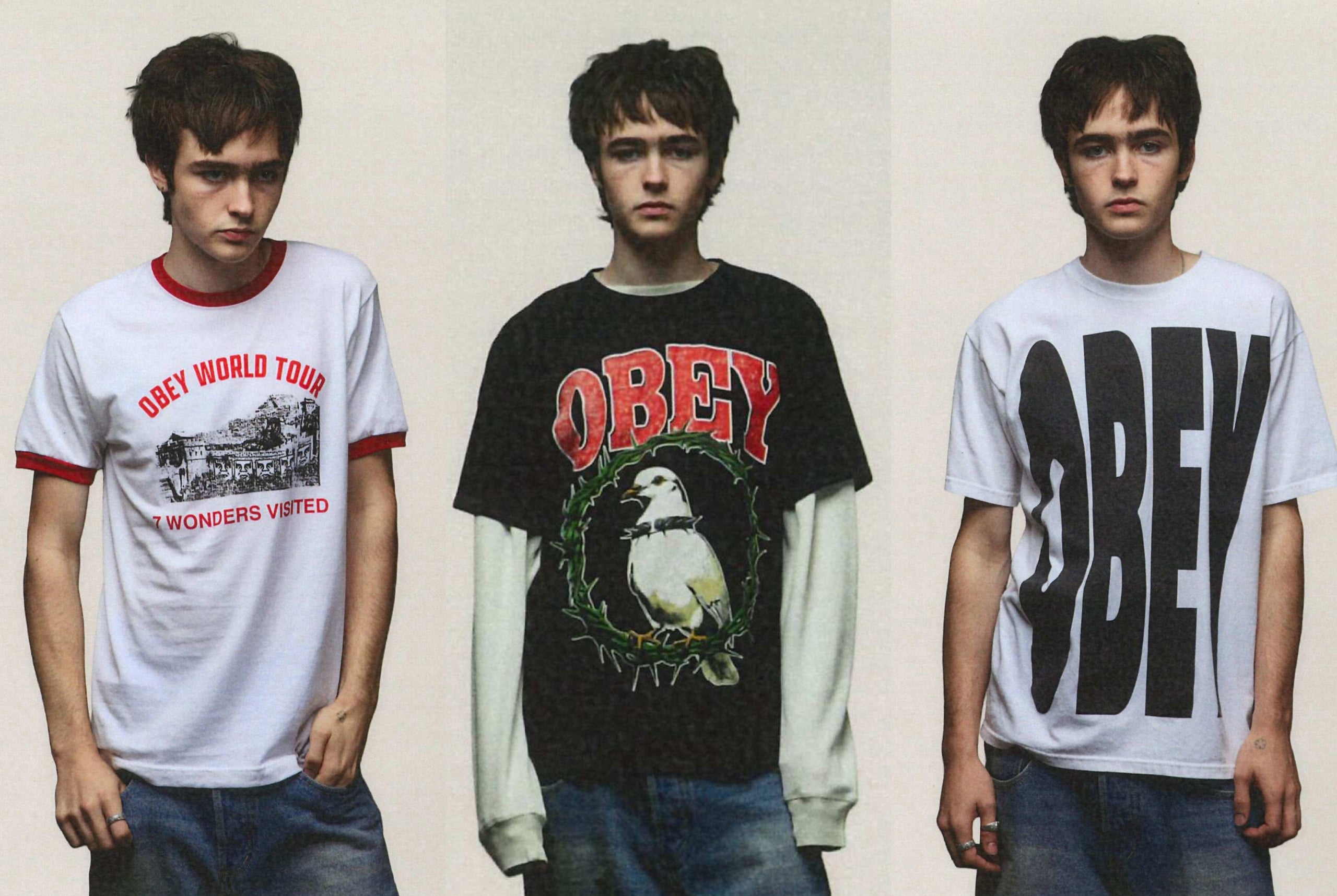 Three young men modeling Obey Obey band merchandise t-shirts against a plain beige background. The left shirt is white with red trim and red text reading 'OBEY WORLD TOUR I WONDERS VOTED'.