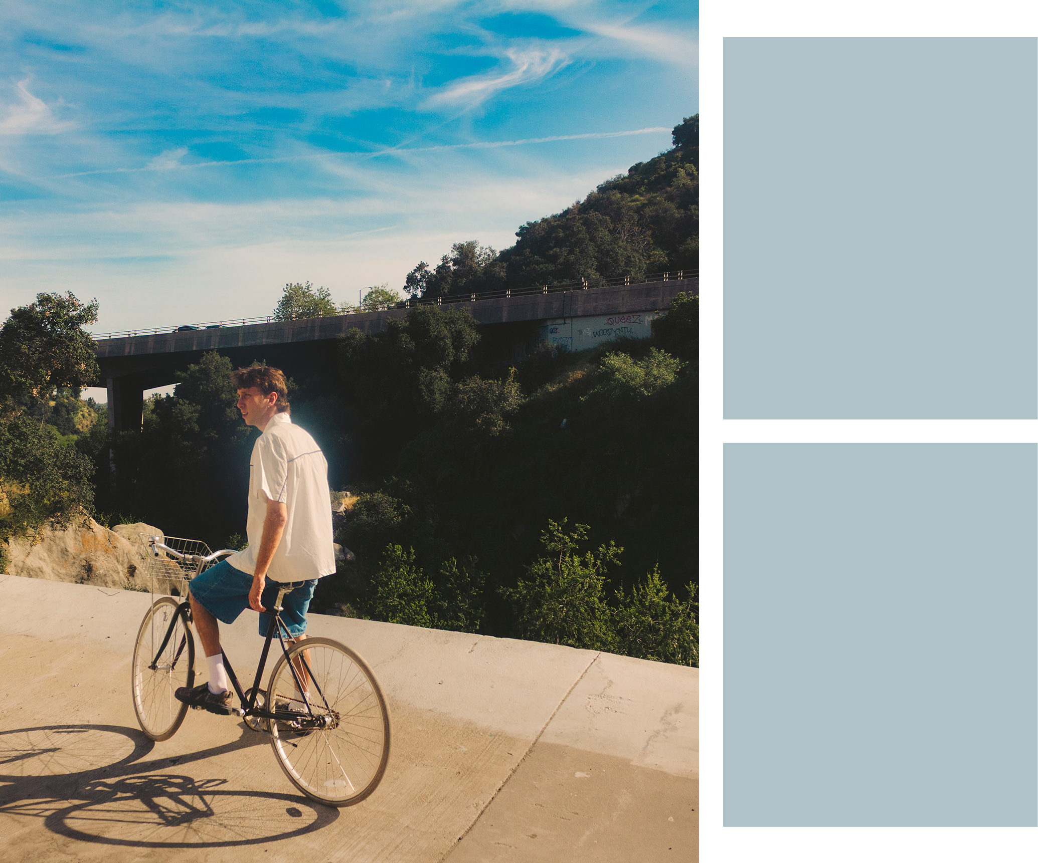 Man with a bicycle on a road with a scenic background